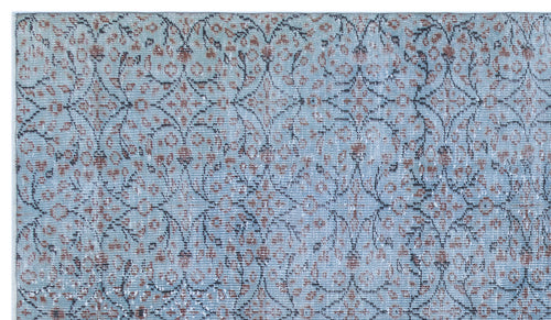 Load image 1 in gallery view. Light blue rug with a distressed floral medallion pattern in rust and charcoal grey.