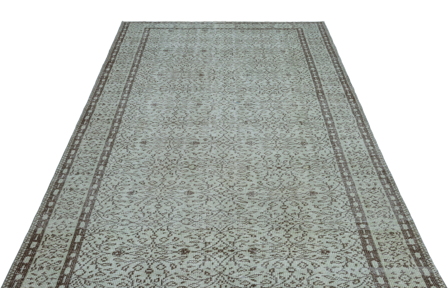 Light gray and brown vintage-style rug with an intricate floral medallion pattern and a double-bordered edge.