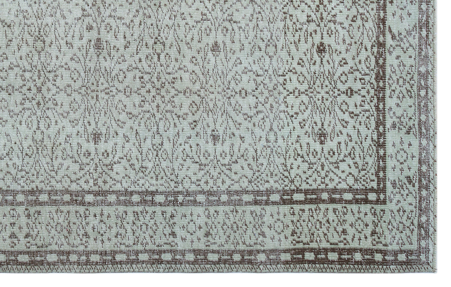 Light gray and brown rug with a distressed traditional floral medallion pattern and a geometric border.