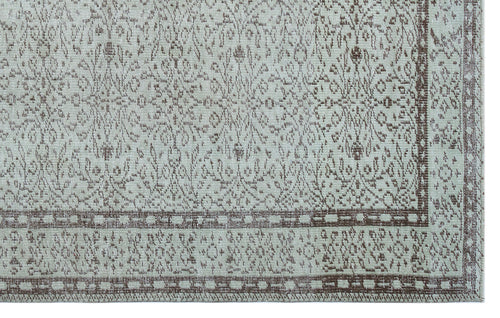 Load image 1 in gallery view. Light gray and brown rug with a distressed traditional floral medallion pattern and a geometric border.