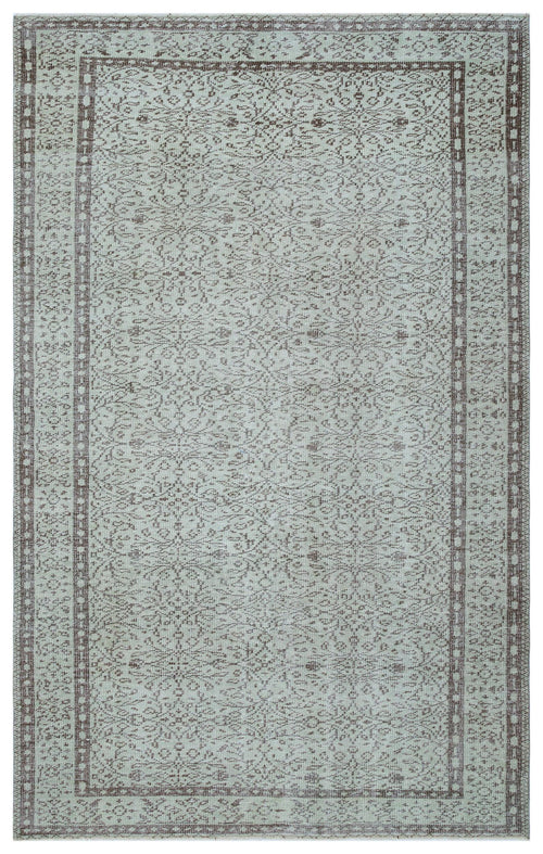 Load image 1 in gallery view. Light blue and brown traditional rug with a distressed floral medallion pattern and a geometric border.