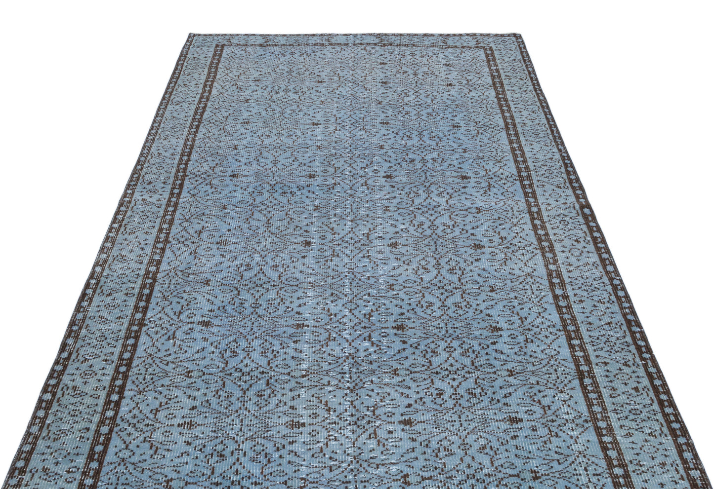 Light blue and dark brown vintage-style rug with an intricate repeating floral pattern and a bordered edge.