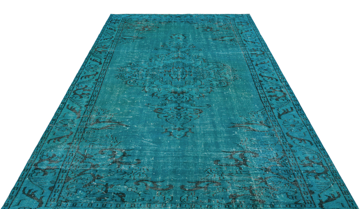 Teal distressed area rug with a dark charcoal traditional medallion pattern and ornate border.