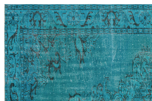 Load image 1 in gallery view. Teal and black distressed rug with a traditional floral medallion border and faded vintage pattern.
