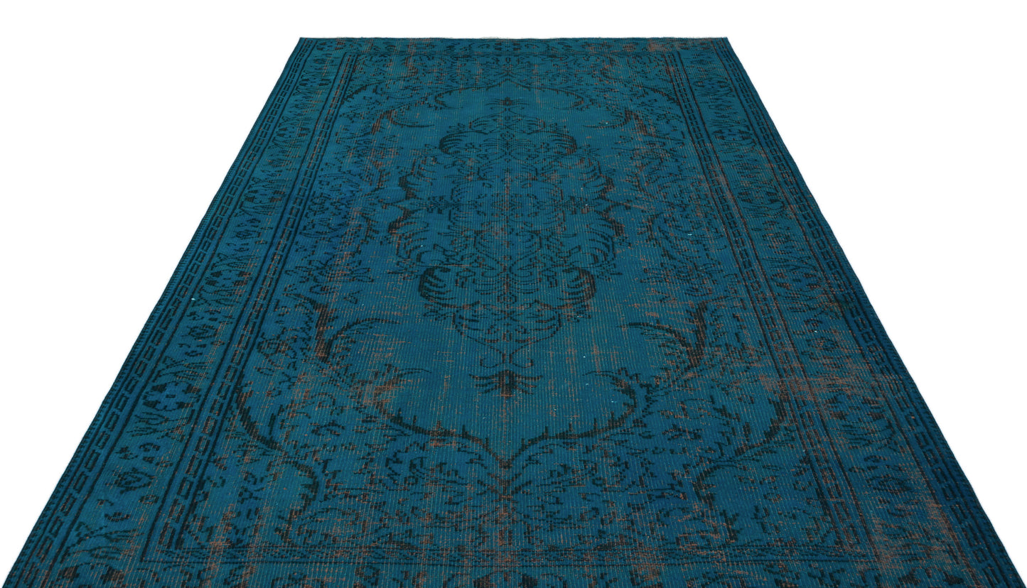 Teal and black distressed traditional rug with a central medallion and ornate border pattern on a white background.