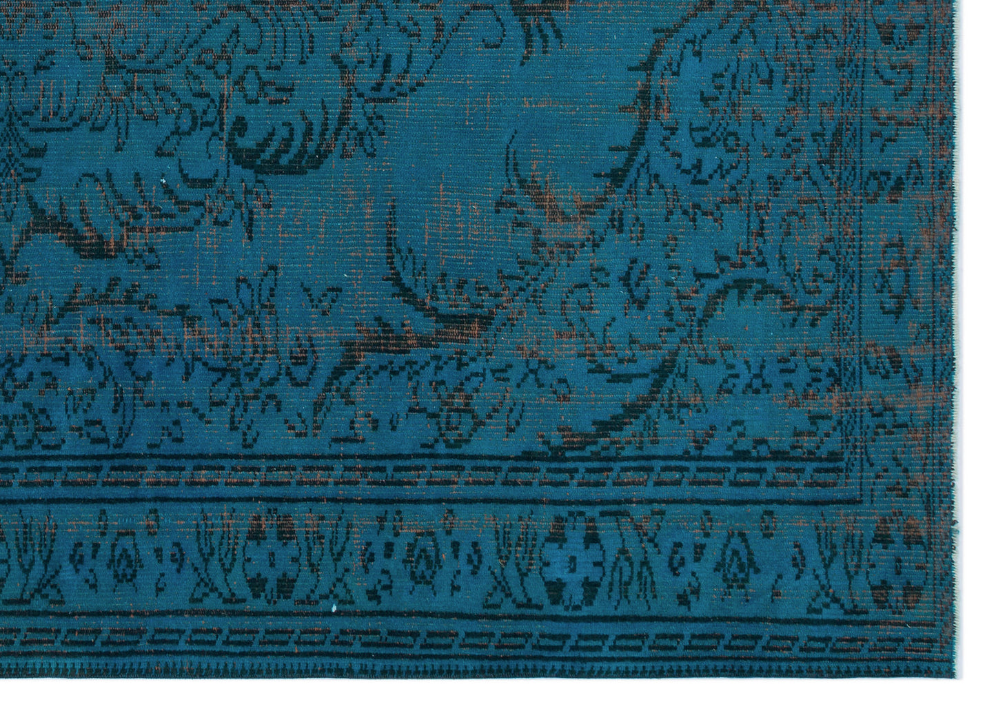 Teal rug with a distressed black floral pattern and a geometric border.