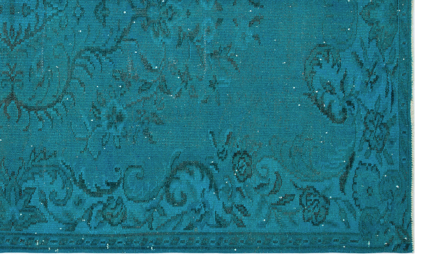 Teal rug with a distressed, dark floral medallion pattern and a bordered edge.