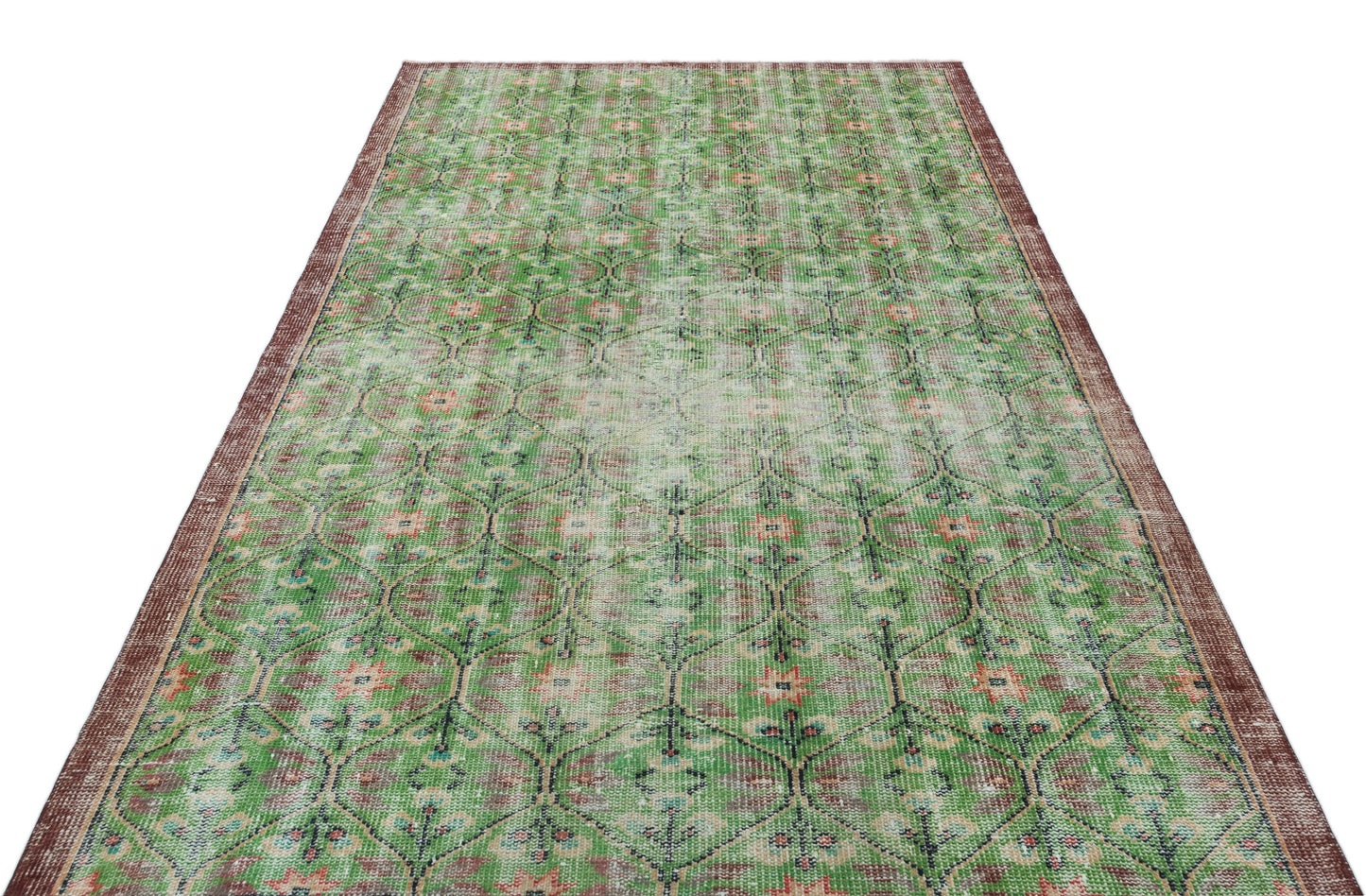 Distressed green and brown vintage-style rug with a repeating geometric floral pattern and a dark border.