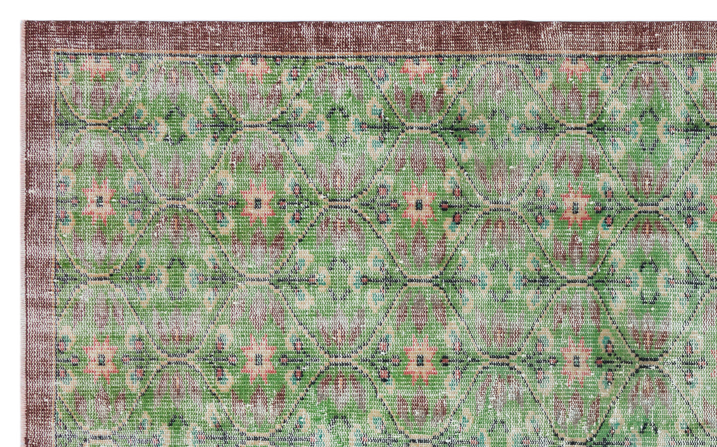Green and brown distressed rug with a repeating geometric diamond pattern and floral motifs.