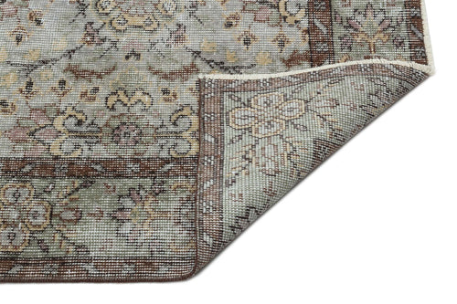 Load image 1 in gallery view. Sage green, brown, and cream traditional floral medallion rug with a corner folded over to show the underside.