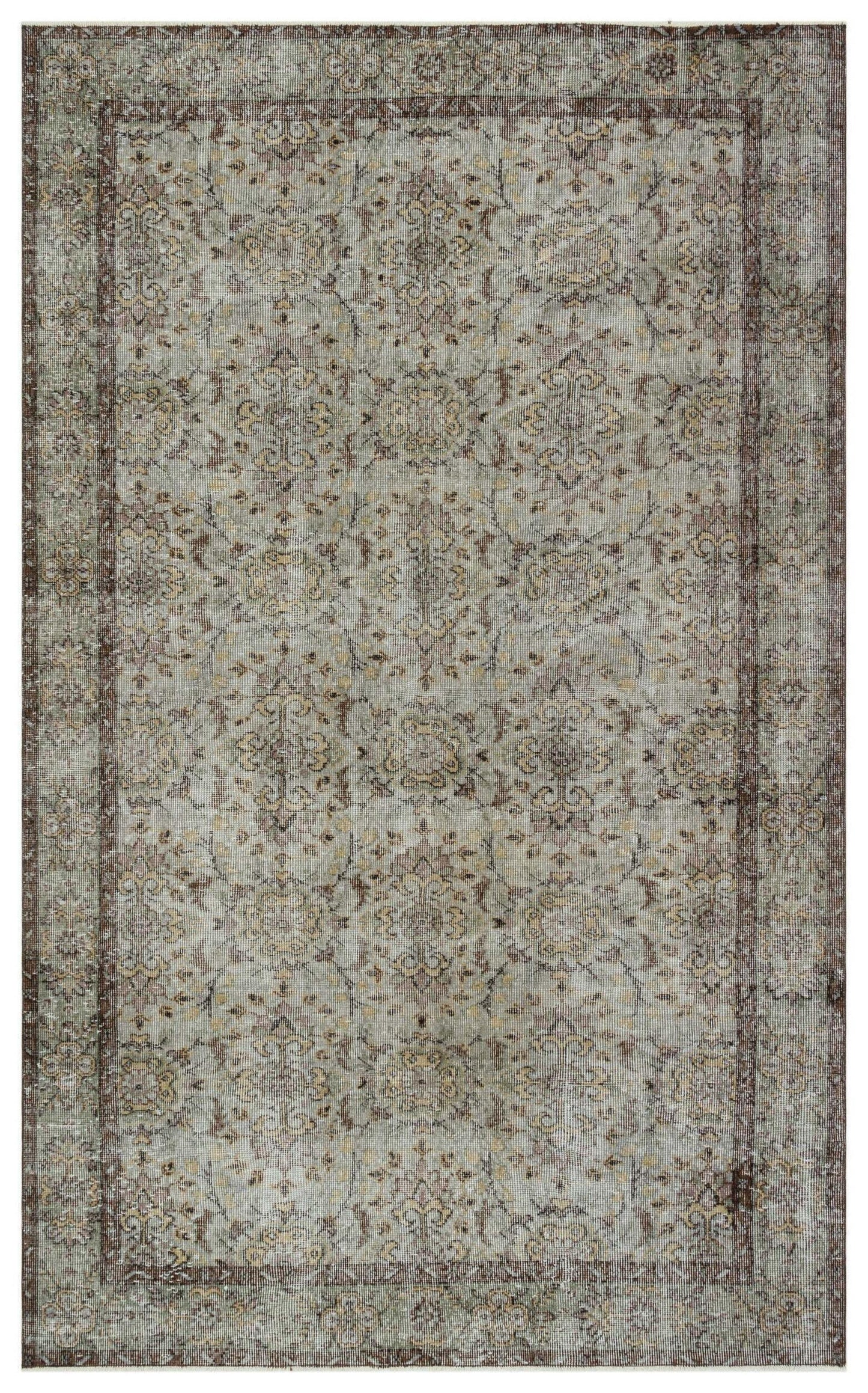 Distressed sage green and brown rug with a traditional floral medallion pattern and a dark border.