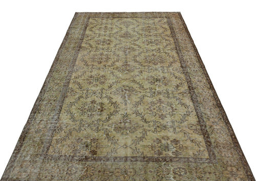 Bild 1 in Galerieansicht laden. Distressed olive and brown vintage rug with a faded floral medallion pattern and a wide decorative border.