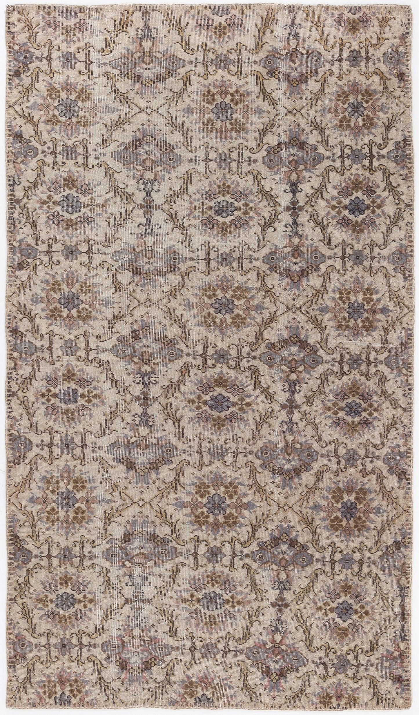 Beige and grey traditional rug with a repeating floral medallion pattern and distressed finish.