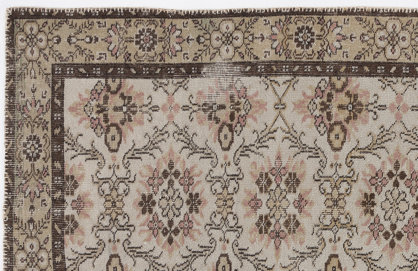 Beige, brown, and muted pink vintage-style rug with a floral medallion border and repeating botanical pattern.