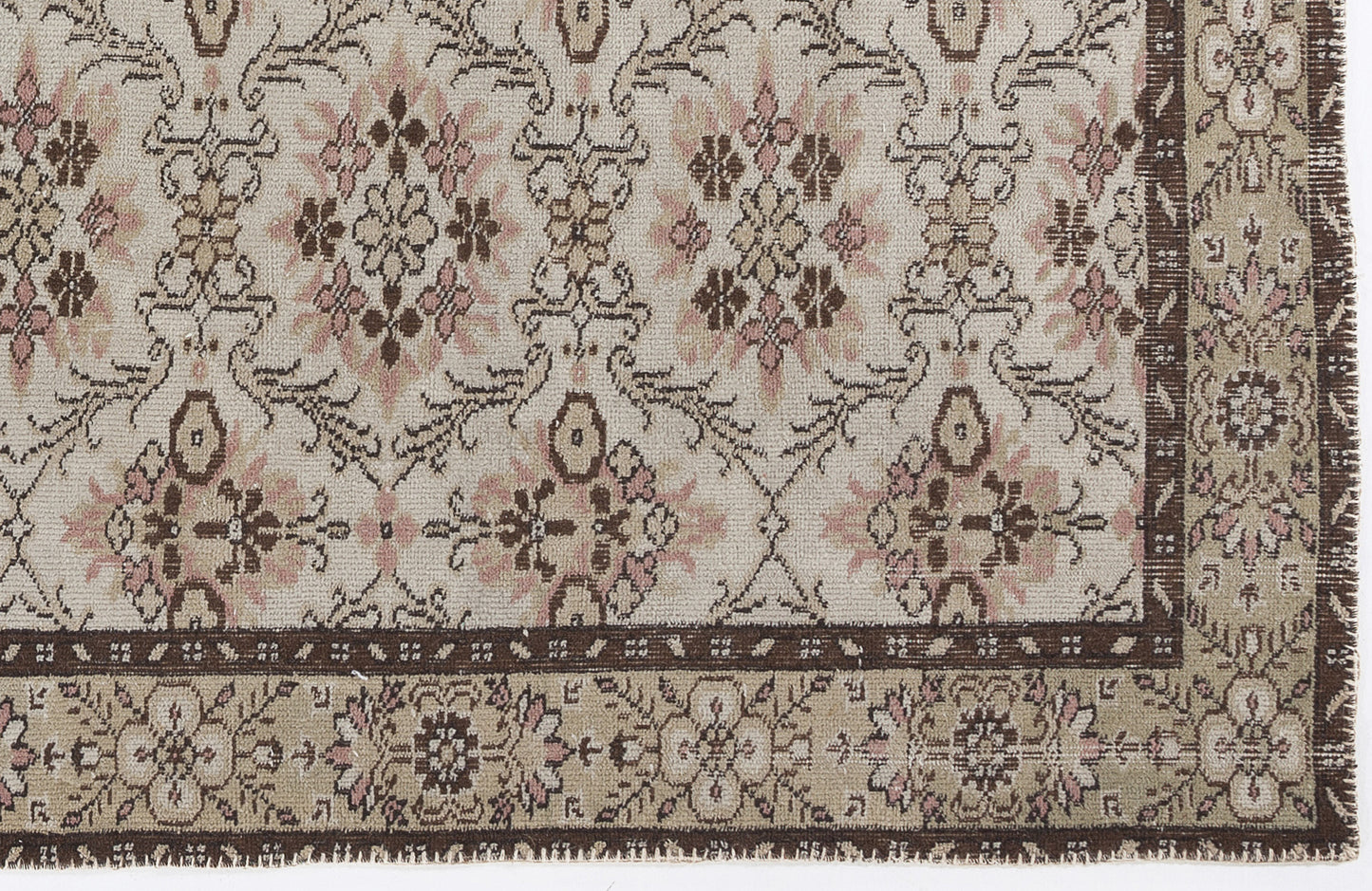 Cream, brown, and dusty pink rug with a traditional floral medallion pattern and a wide decorative border.