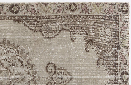 Load image 1 in gallery view. Distressed beige and brown rug with a faded traditional floral medallion pattern and a decorative border.