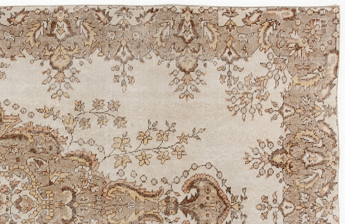 Beige and brown vintage-style rug with a distressed floral medallion pattern on a cream background.