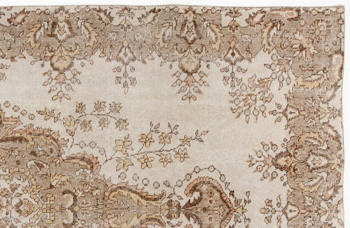 Load image 1 in gallery view. Beige and brown vintage-style rug with a distressed floral medallion pattern on a cream background.