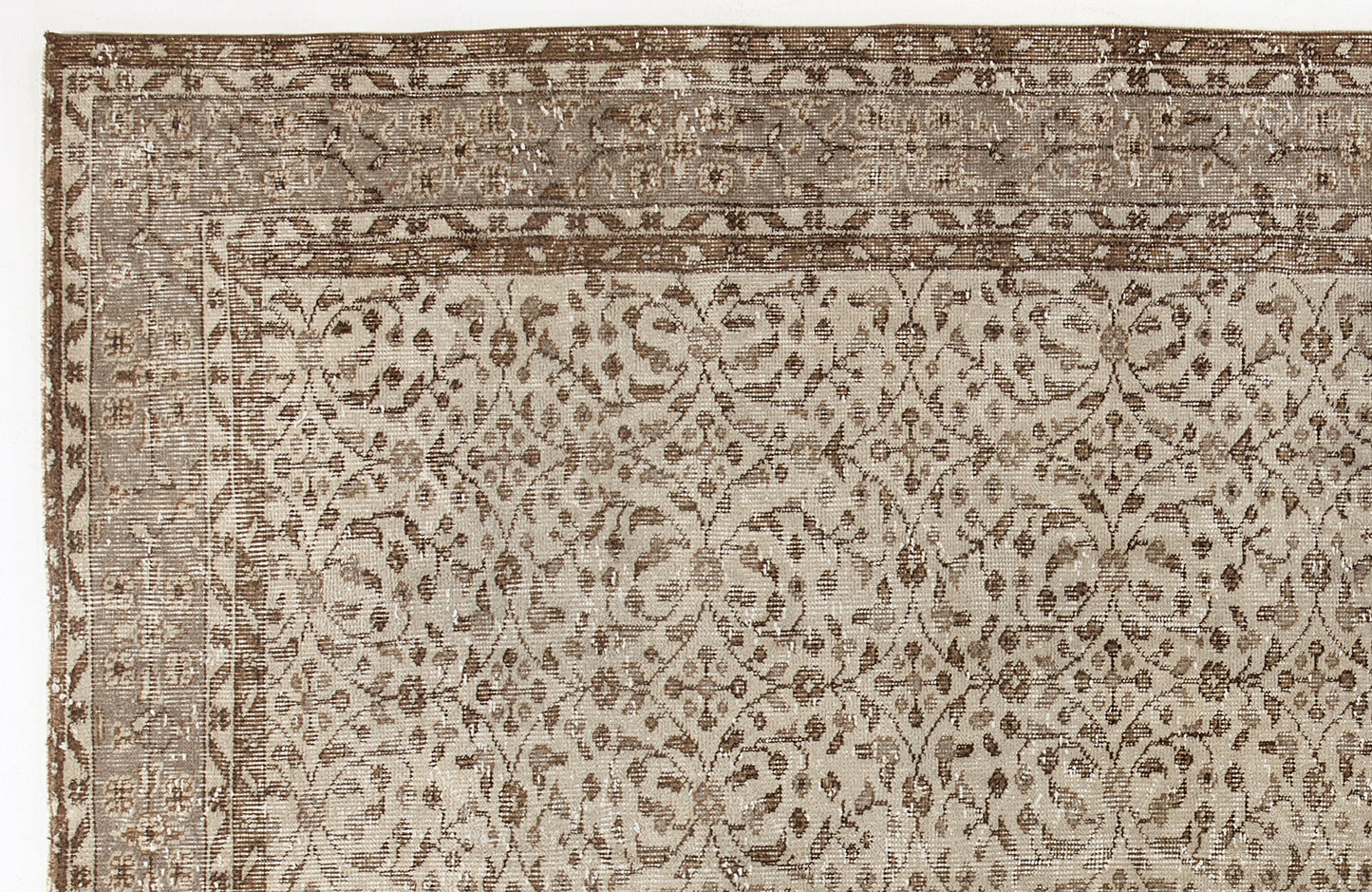 Taupe and brown vintage-style rug with a distressed floral trellis pattern and a decorative border.