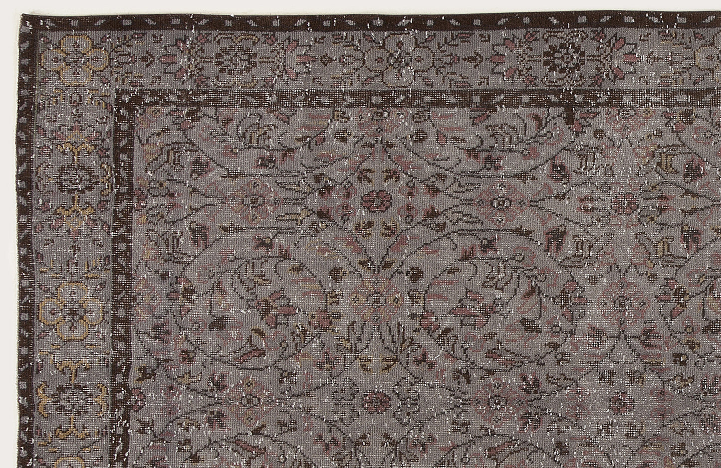 Grey and brown traditional rug with a distressed floral medallion pattern and a dark border.