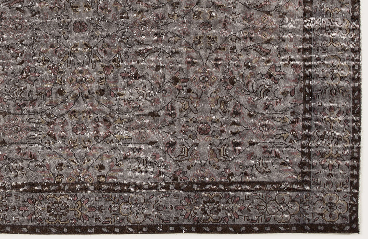 Grey and brown distressed rug with a traditional floral medallion pattern and a detailed border.