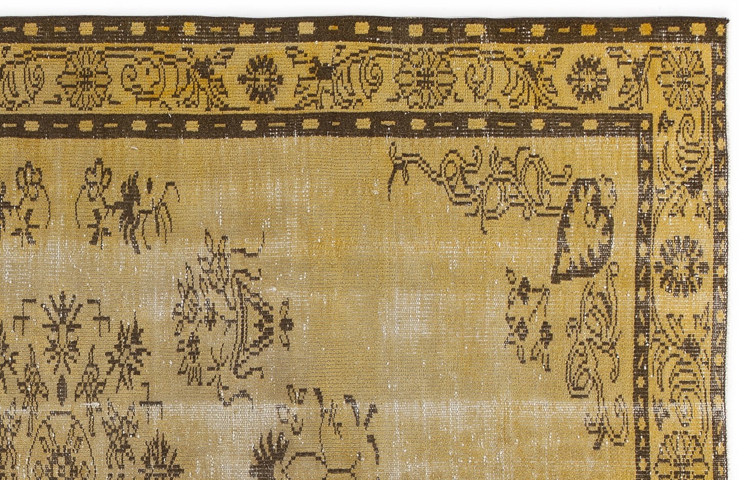 Mustard yellow and dark brown distressed rug with a traditional floral border and scattered botanical motifs.