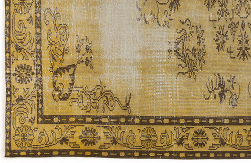 Load image 1 in gallery view. Distressed ochre and brown vintage-style rug with a faded floral medallion border and central motif.