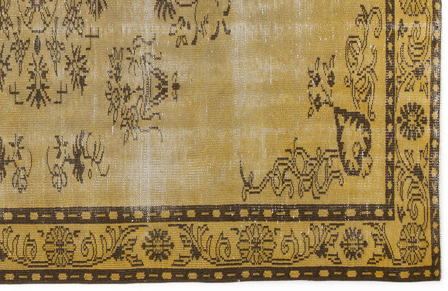 Distressed mustard yellow and dark brown rug with a traditional floral medallion border and faded central motifs.