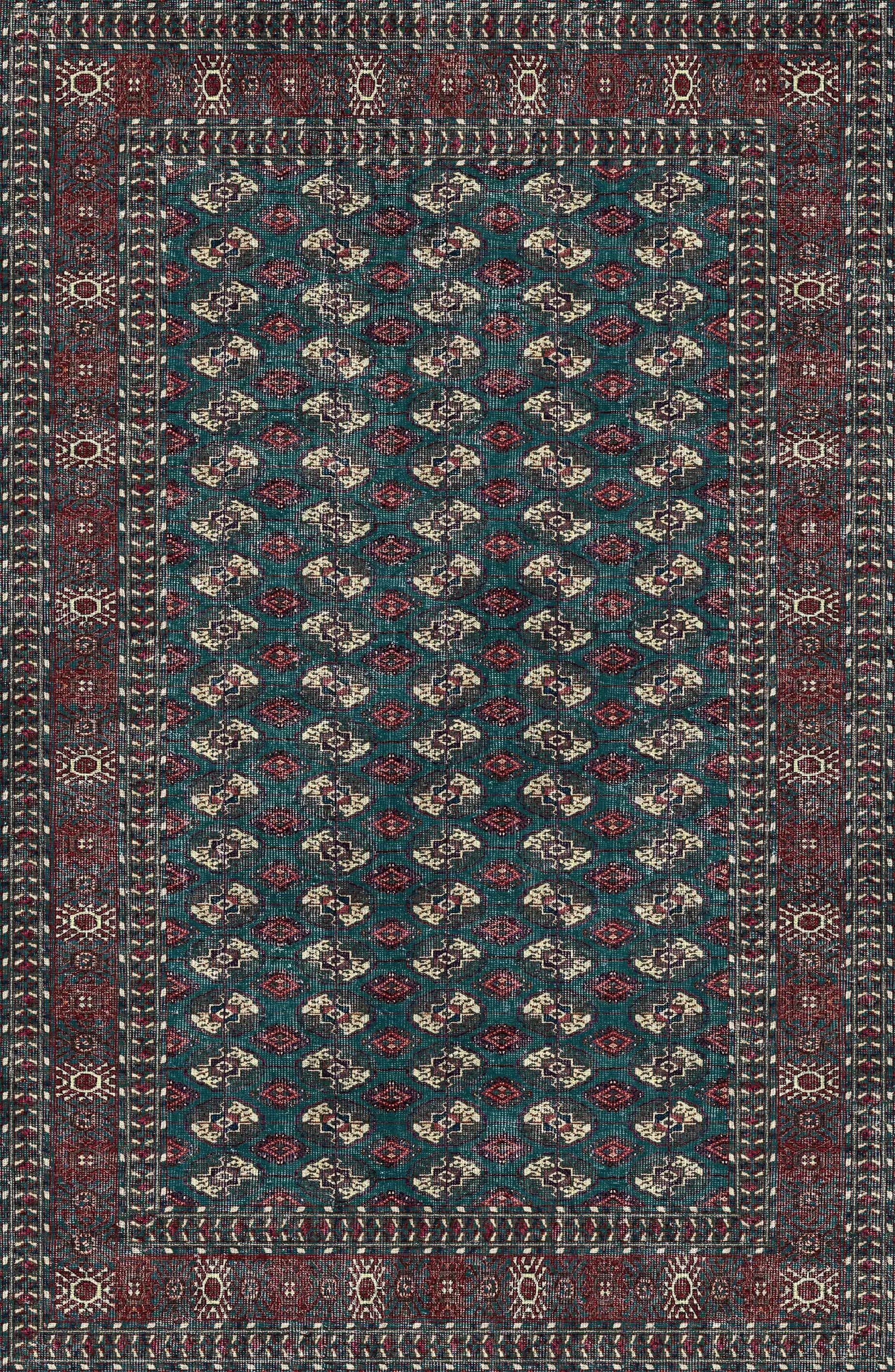 Patterned rug with a blue and red design on a dark background