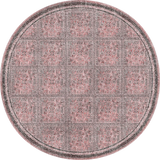 Round rug with a geometric pattern in pink and gray