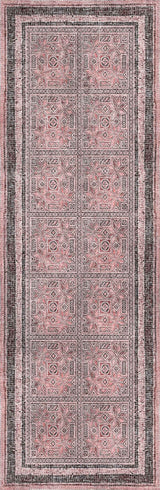 Patterned rug with a mix of pink and gray colors on a dark background