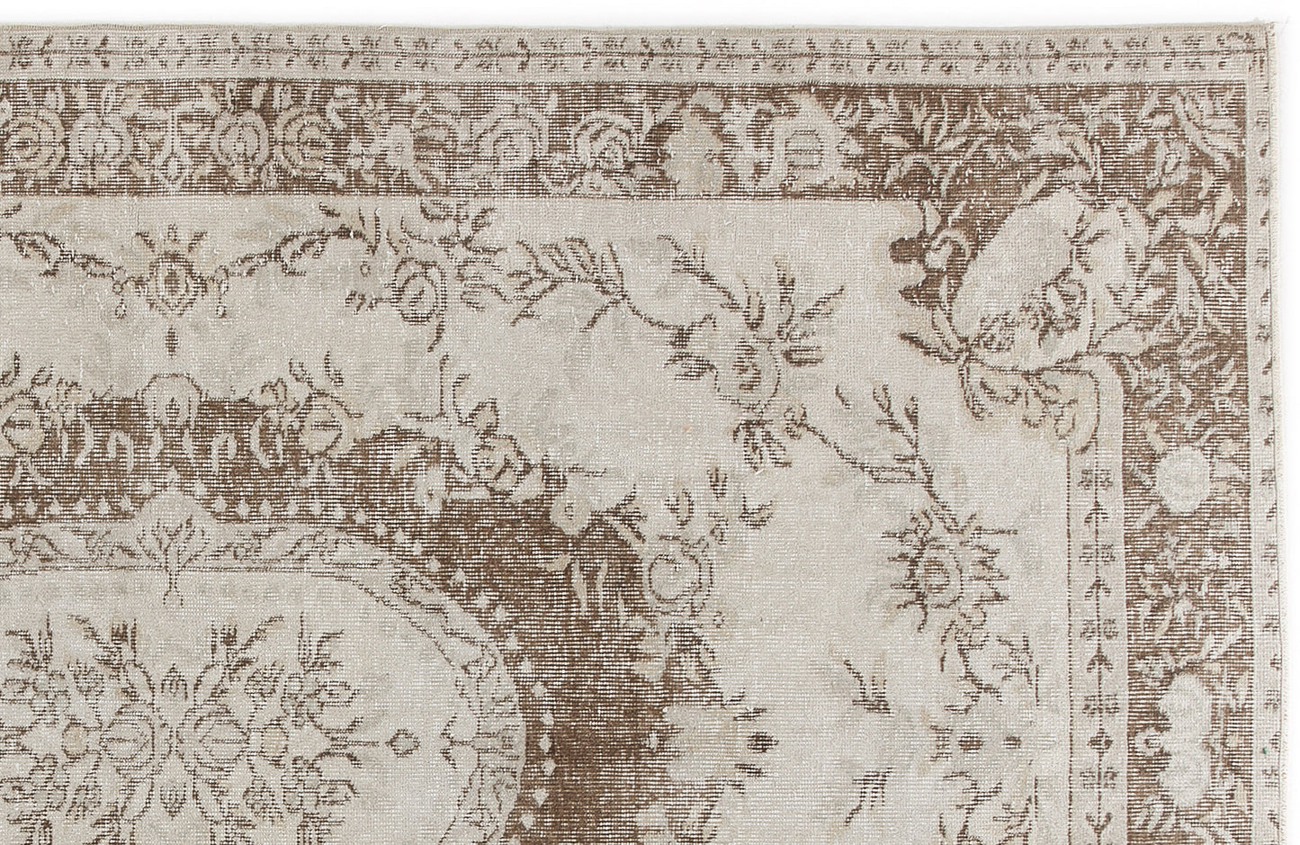 Beige and brown traditional rug with a distressed floral medallion pattern and ornate border.