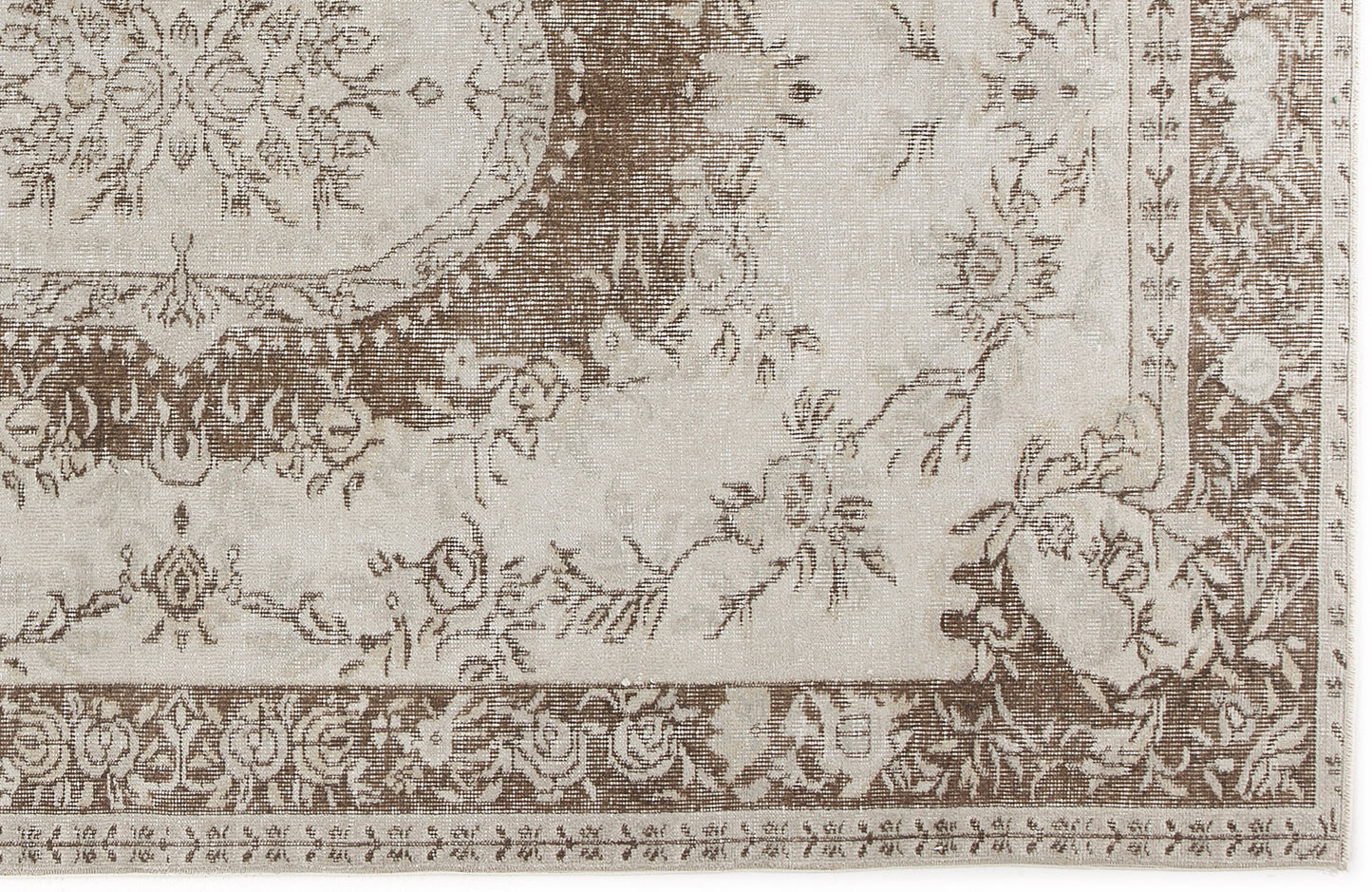 Taupe and cream traditional rug with a distressed floral medallion pattern and ornate border.