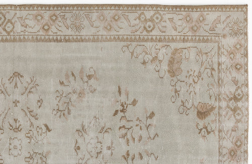 Load image 1 in gallery view. Light gray and tan vintage-style rug with a faded floral medallion pattern and a decorative geometric border.