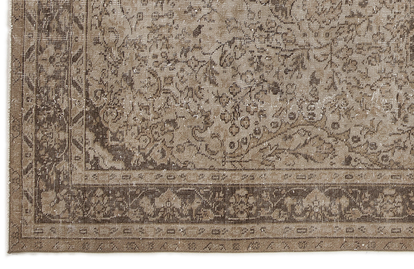 Distressed brown and beige rug with a traditional floral medallion pattern and a detailed geometric border.