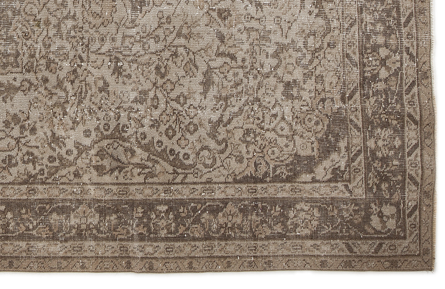 Taupe and brown vintage-style rug with a distressed floral medallion pattern and a detailed border.