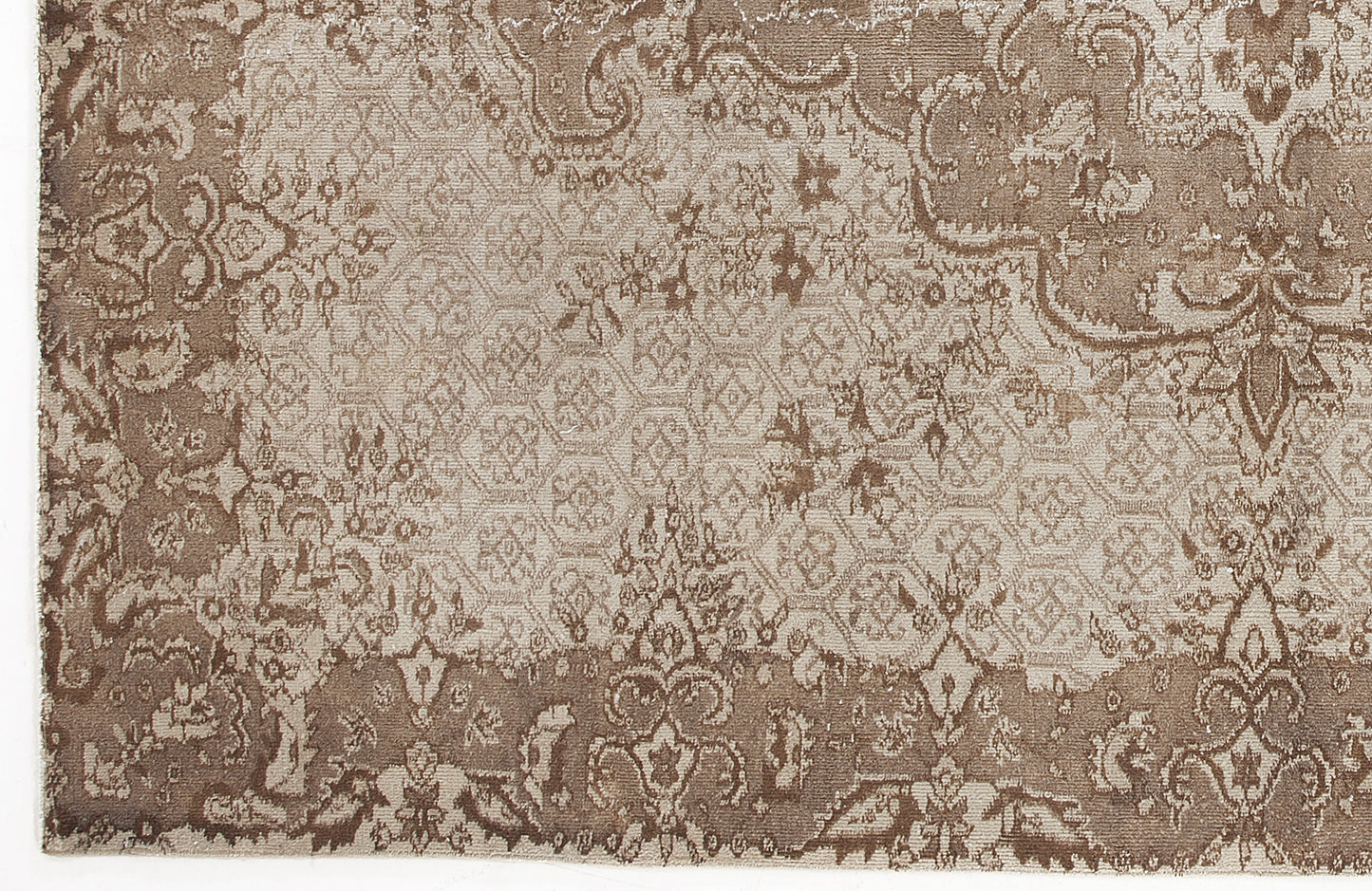 Taupe and beige rug with a distressed traditional floral medallion pattern and a geometric honeycomb center.