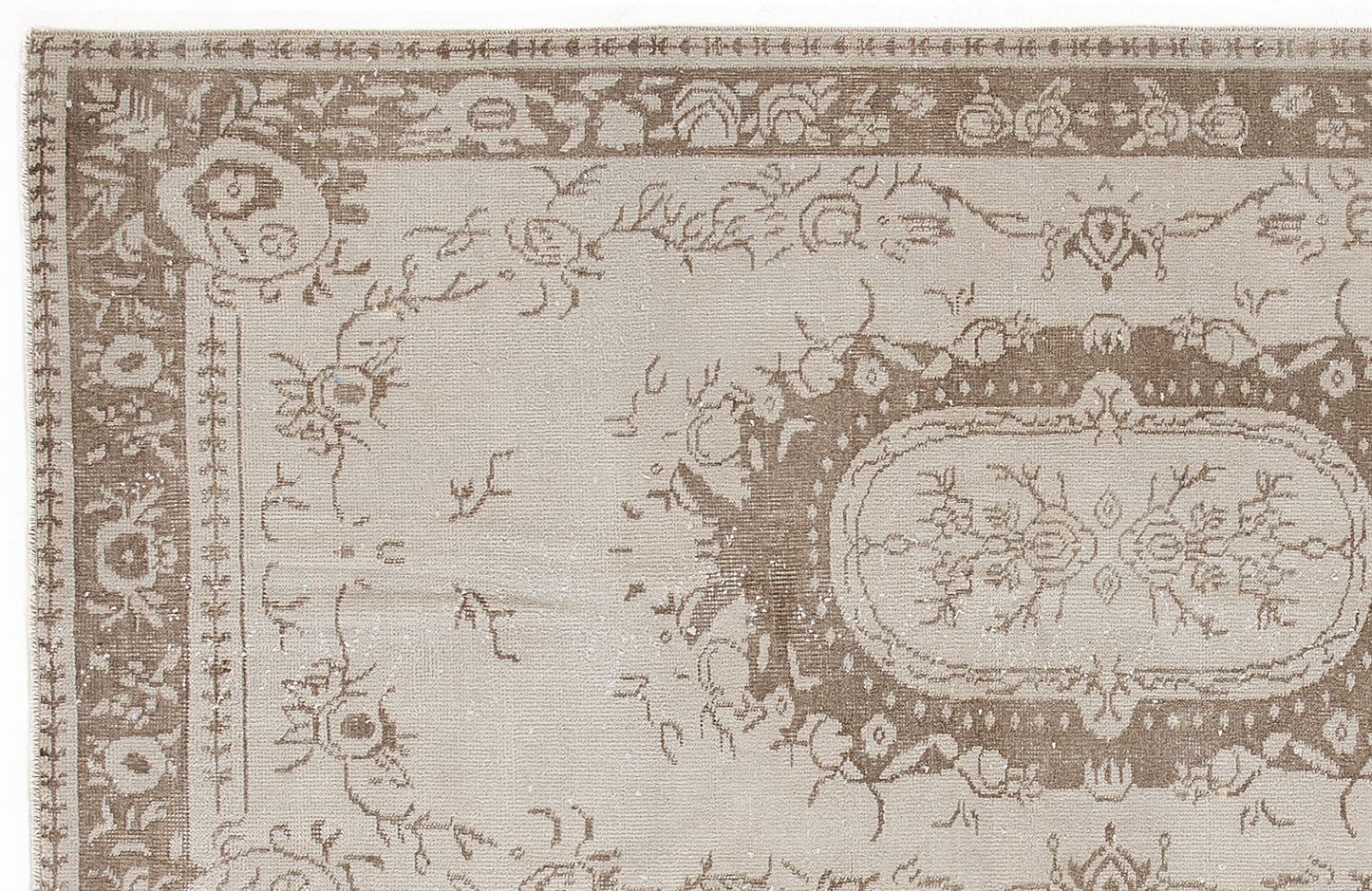 Taupe and beige traditional rug with a distressed floral medallion pattern and ornate border.
