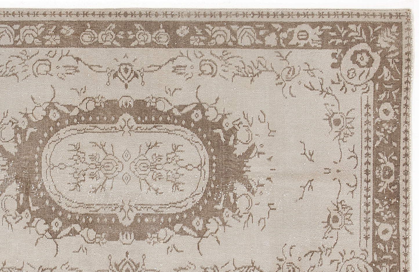 Taupe and beige traditional rug with a distressed floral medallion pattern and a decorative border.