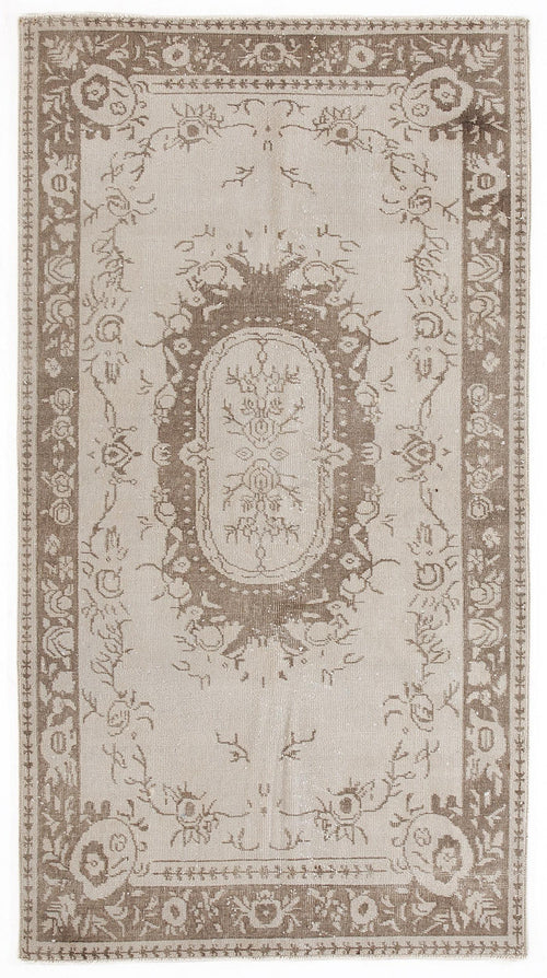 Load image 1 in gallery view. Taupe and beige vintage-style rug with a central floral medallion and a decorative border.