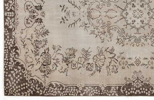 Load image 1 in gallery view. Taupe and dark brown rug with a traditional floral medallion pattern and ornate border.
