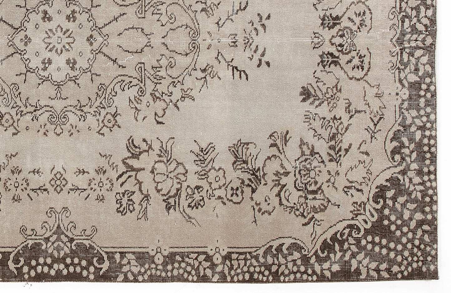 Taupe and dark brown rug with a traditional floral medallion pattern and a decorative border.