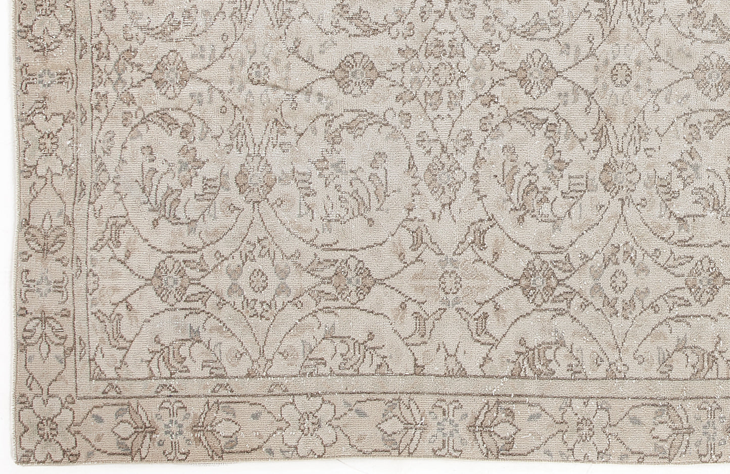 Beige and taupe rug with a traditional floral medallion pattern and a decorative border.
