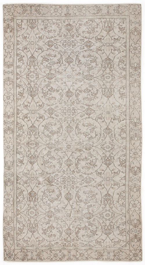 Load image 1 in gallery view. Beige and taupe traditional rug with a distressed floral vine pattern and a decorative border.