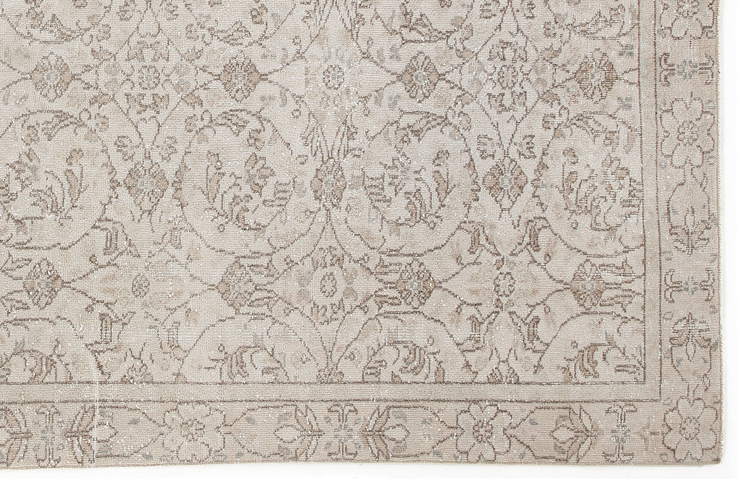 Beige and taupe traditional rug with a distressed floral medallion pattern and a decorative border.