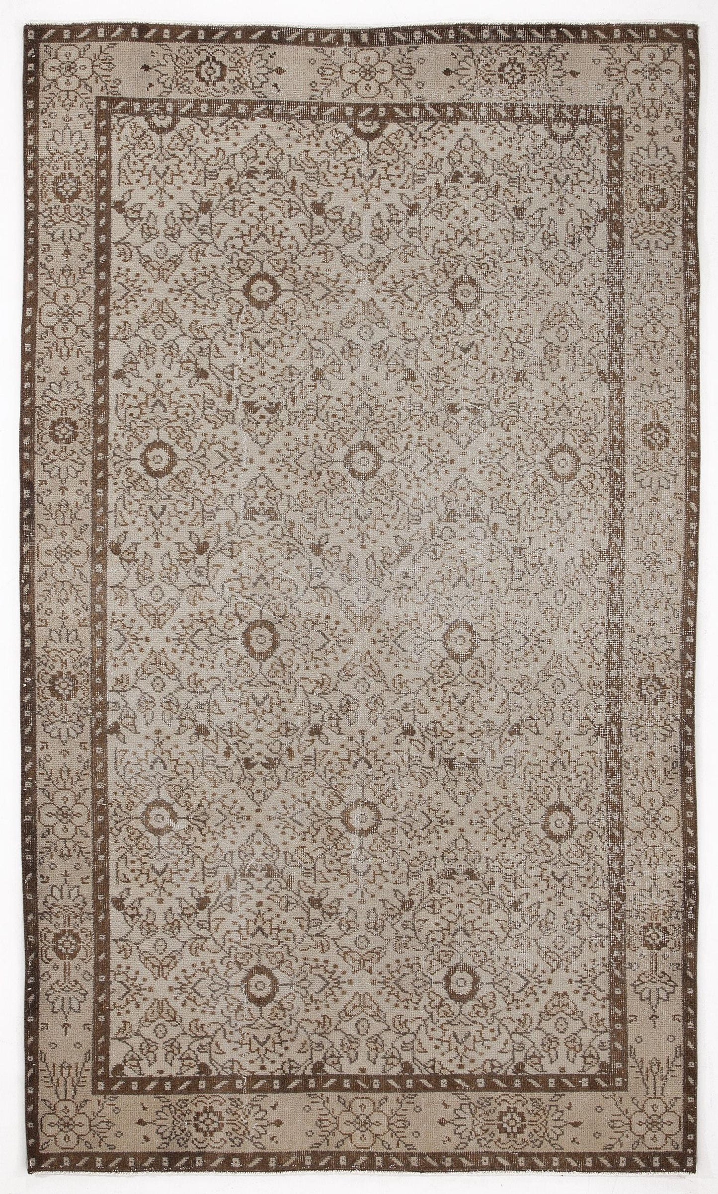 Beige and brown traditional rug with a distressed floral medallion pattern and a wide decorative border.