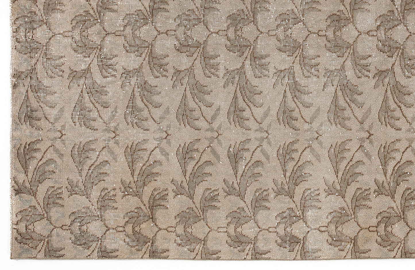 Taupe and beige rug with a repeating distressed botanical leaf pattern.