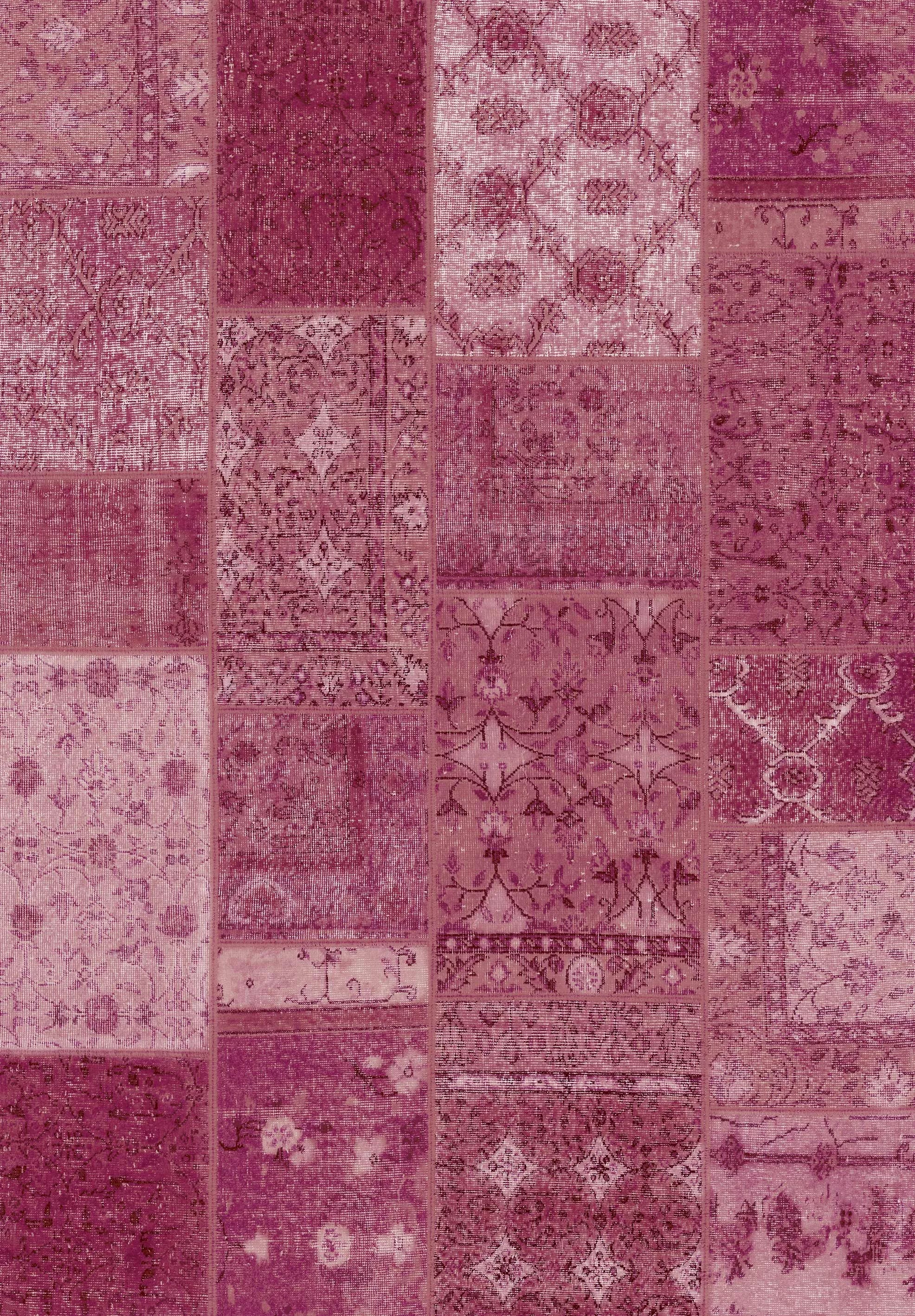 Patchwork pattern with various shades of purple and pink on a textured fabric background