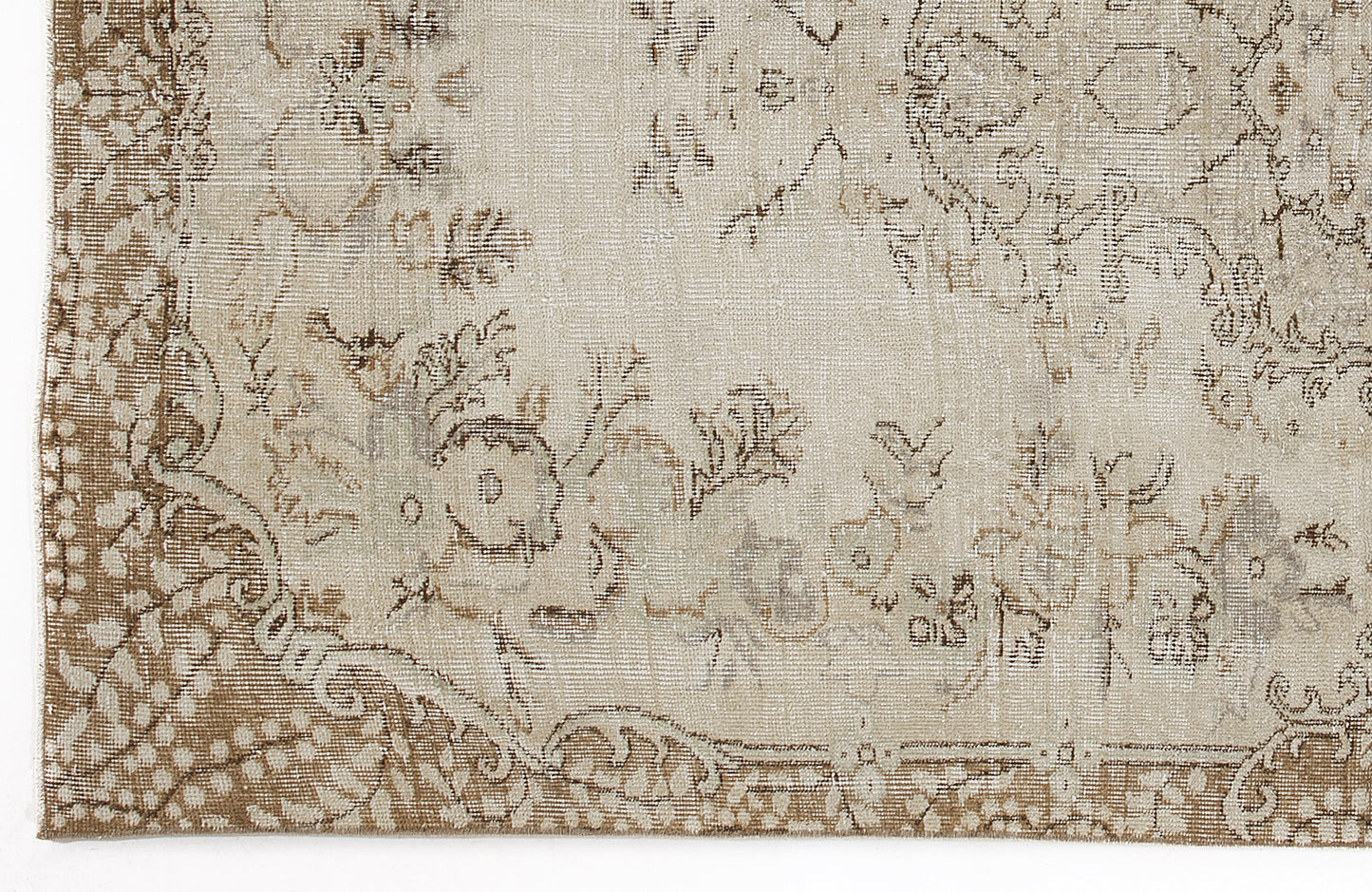 Beige and taupe vintage-style rug with a distressed floral medallion pattern and ornate border.