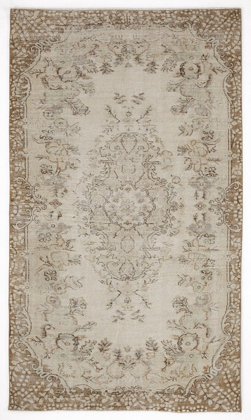 Load image 1 in gallery view. Beige and brown distressed area rug with a central floral medallion and ornate border on a white background.